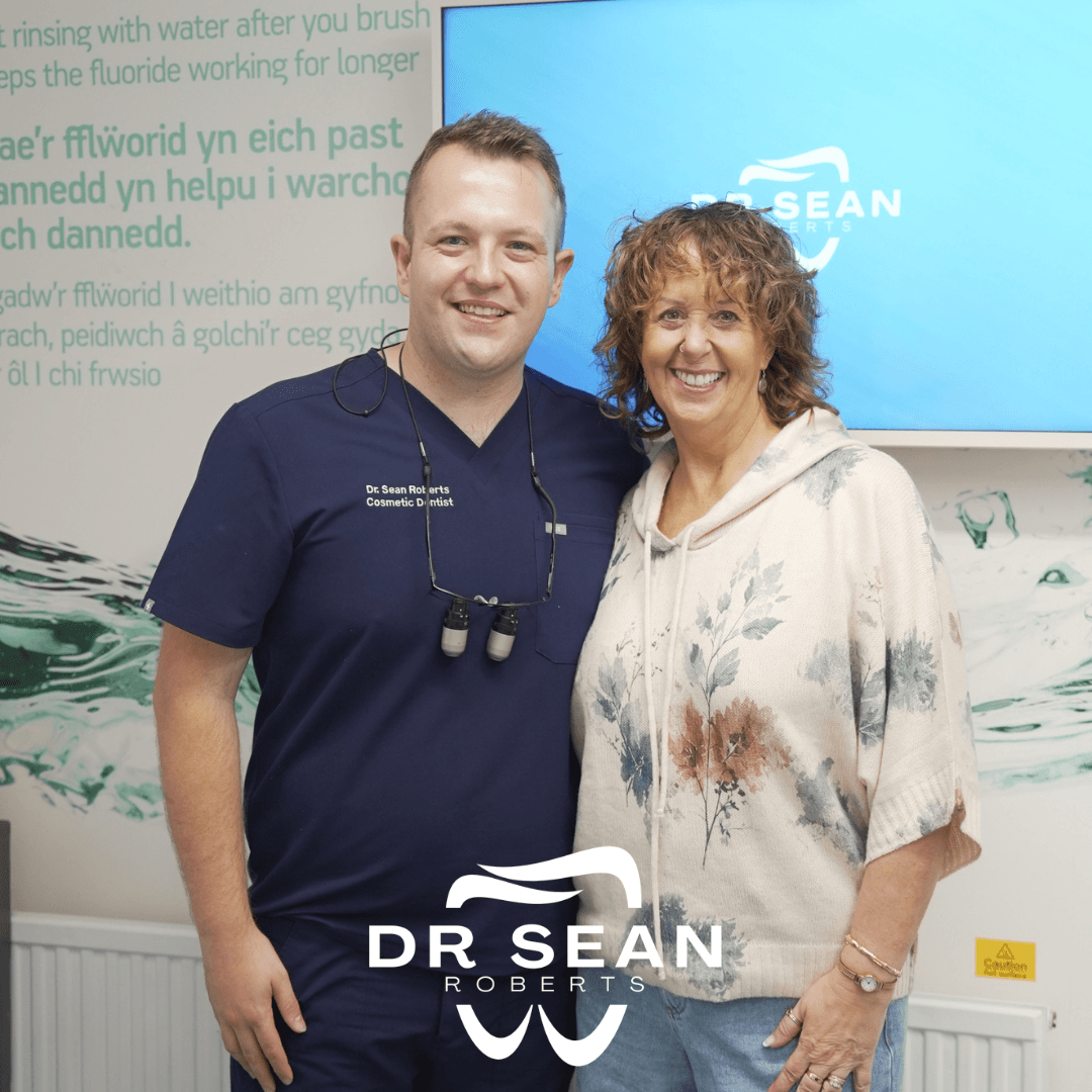 Dr Sean Roberts with a smiling patient at his Aberystwyth dental practice