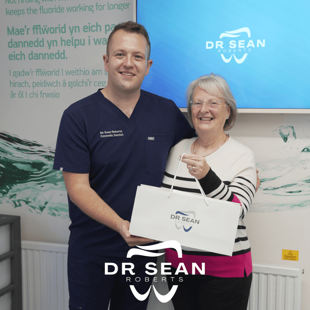 Dr Sean Roberts presenting a patient with a Dr Sean Roberts gift bag in Aberystwyth