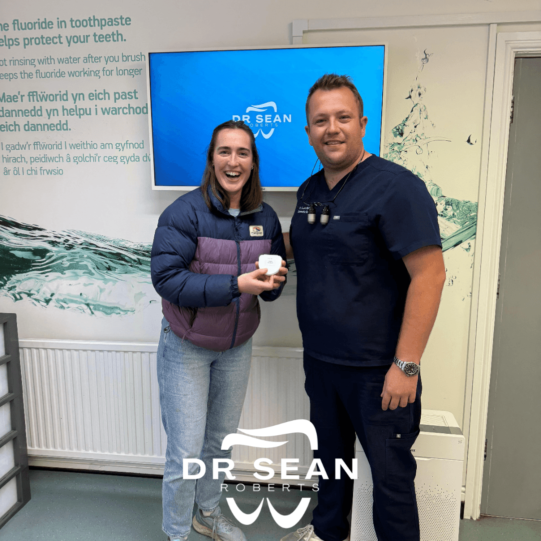 Dr Sean Roberts with a patient following dental care in Aberystwyth