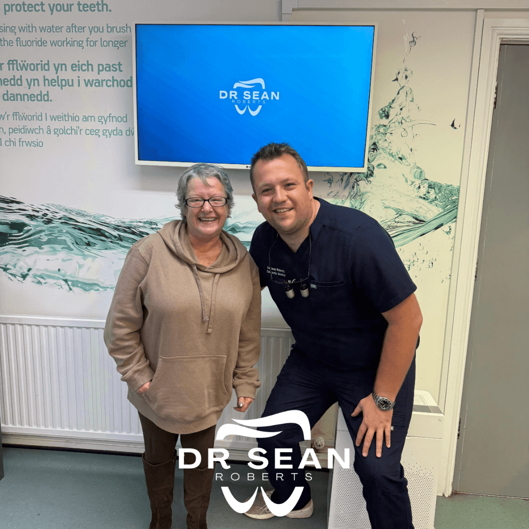 Dr Sean Roberts with a smiling patient at his Aberystwyth dental practice