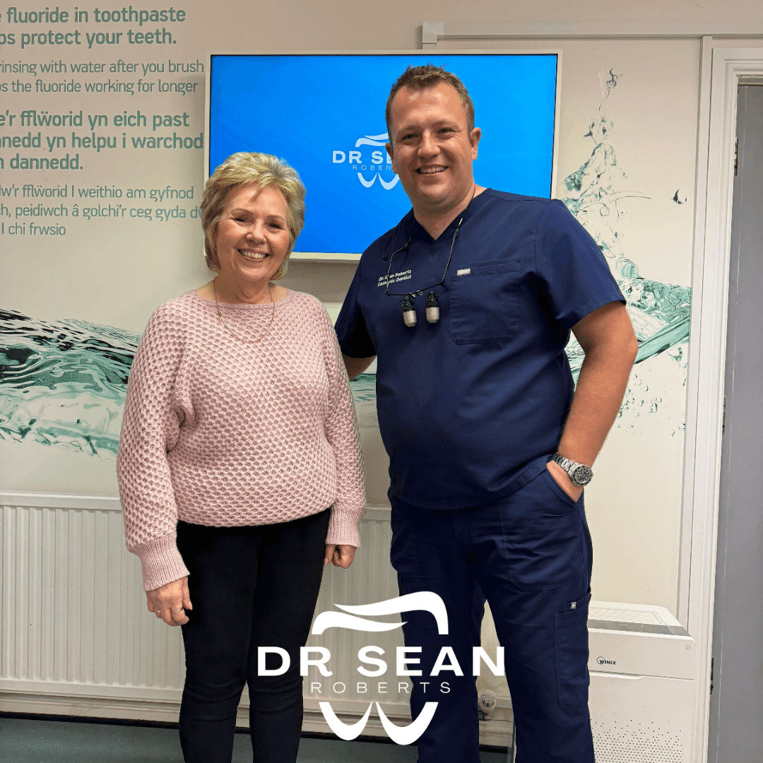 Dr Sean Roberts with a smiling patient following dental care in Aberystwyth