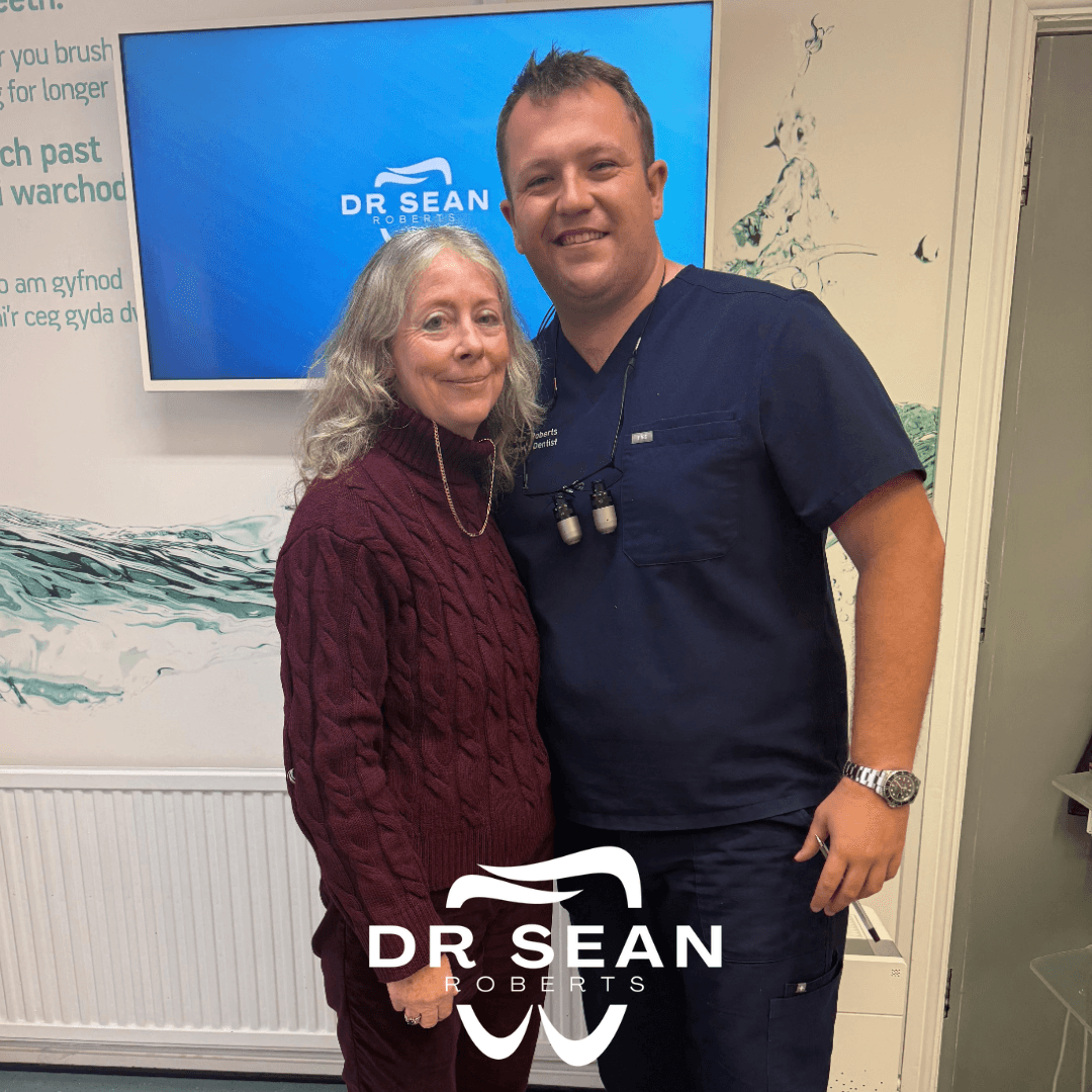 Dr Sean Roberts with a patient at his dental practice in Aberystwyth
