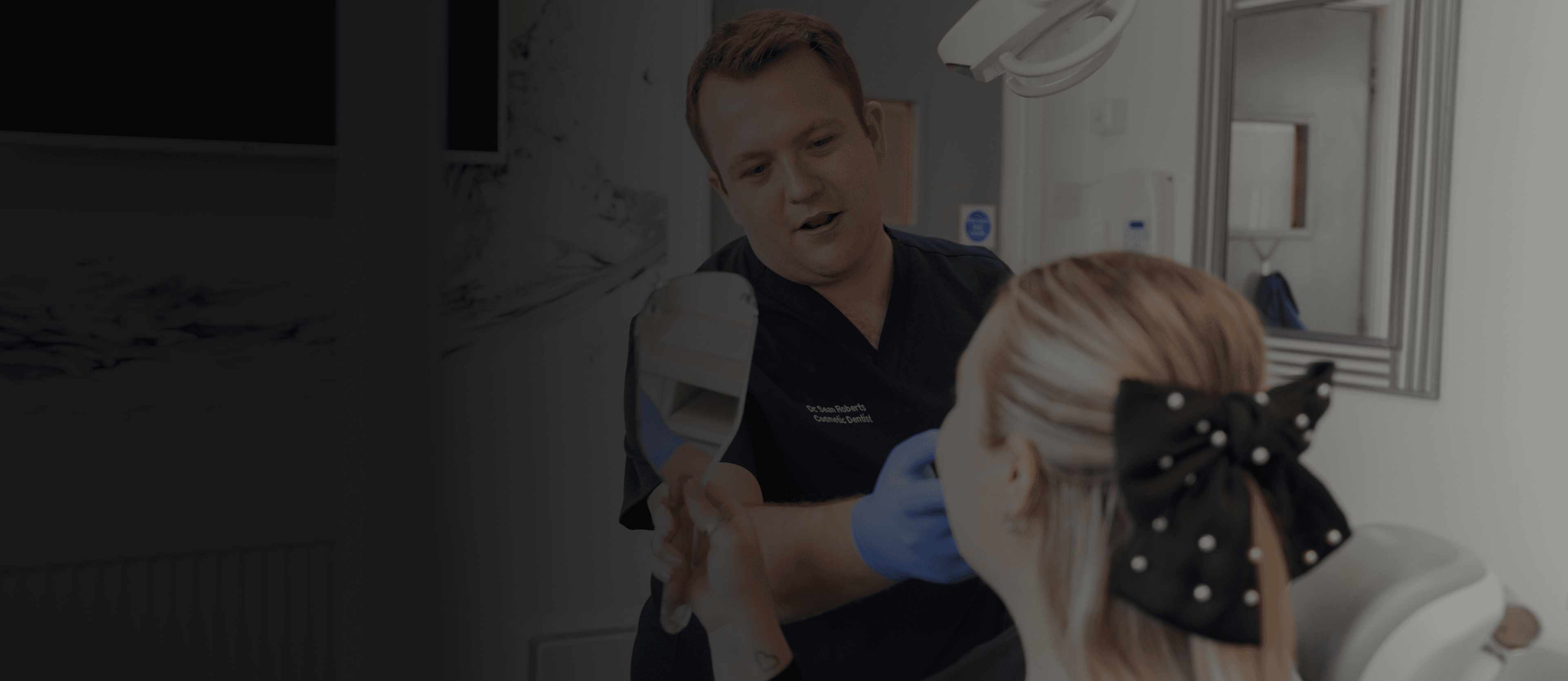 Dr Sean Roberts discussing a patient's smile at his dental practice in Aberystwyth