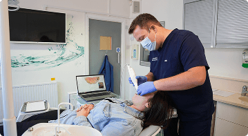 Dr Sean Roberts providing dental treatment to a patient at Friars Dental Clinic in Aberystwyth
