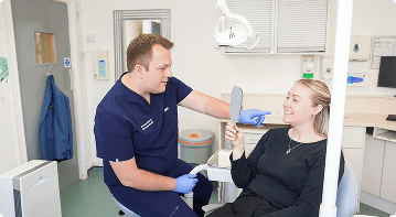 Dr Sean Roberts discussing restorative dentistry with a patient in Aberystwyth
